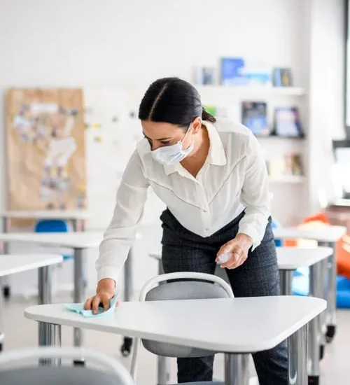 Disinfecting a classroom desk