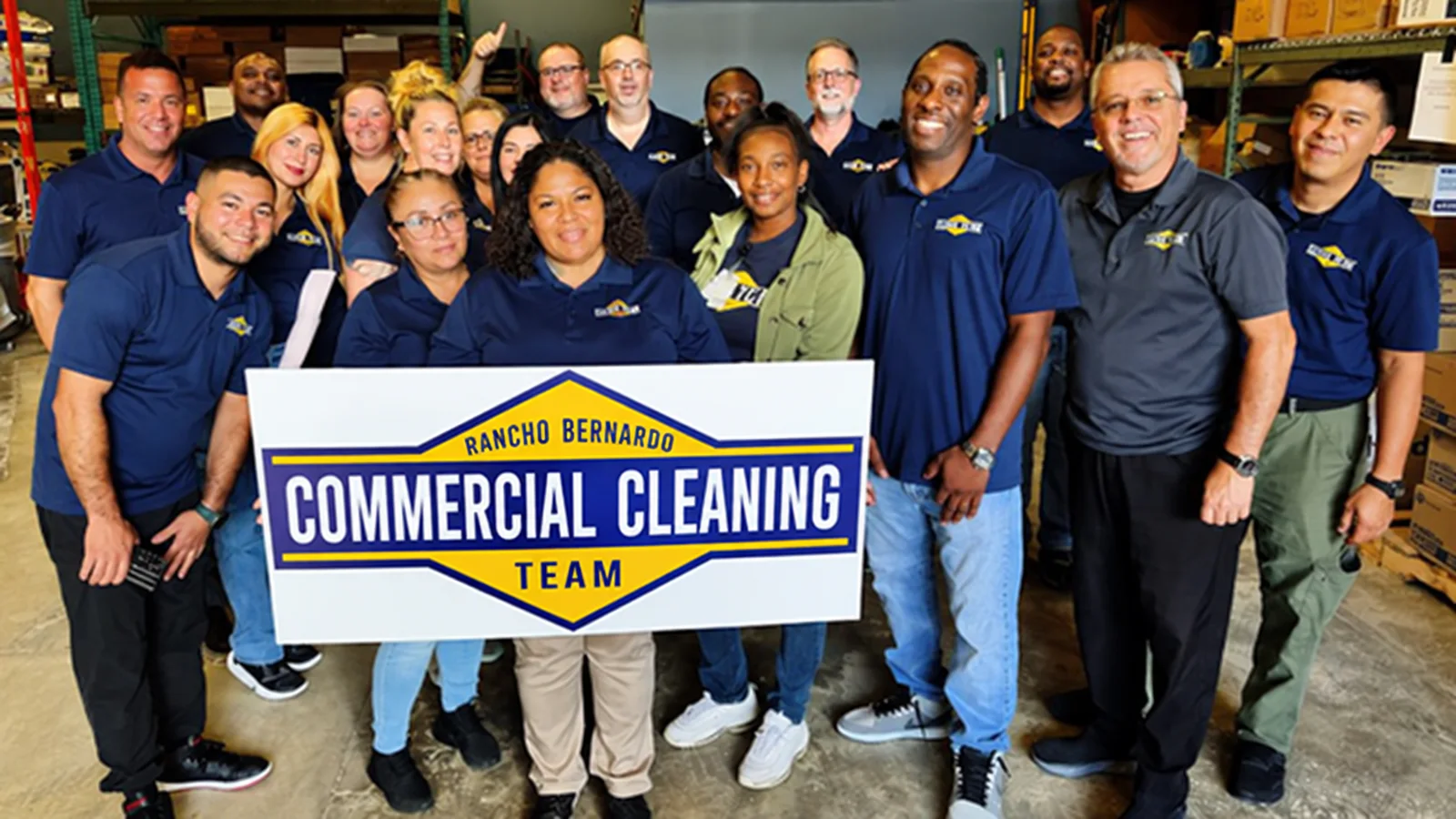 The Rancho Bernardo Commercial Cleaning team holding the company sign