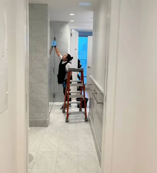Janitor dusting high surfaces