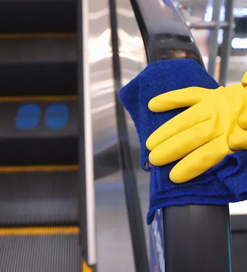 Wiping an escalator handrail